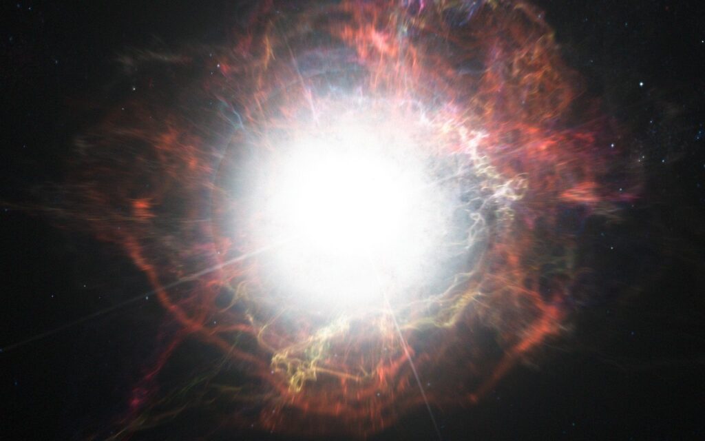 This artist’s impression shows dust forming in the environment around a supernova explosion. VLT observations have shown that these cosmic dust factories make their grains in a two-stage process, starting soon after the explosion, but continuing long afterwards. Credit:ESO/M. Kornmesser